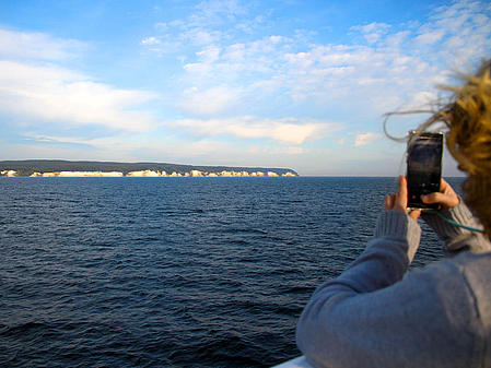 Woman photographs chalk cliffs with mobile phone