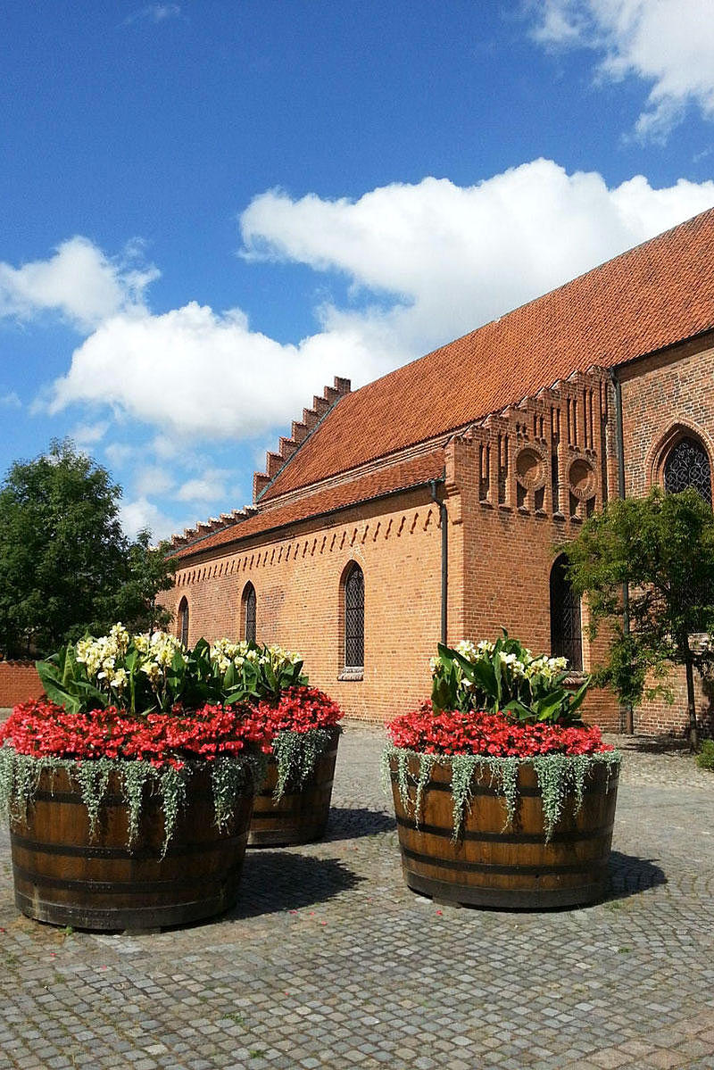 Flower tubs stand in front of the monastery in Ystad